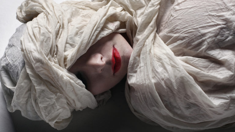 Model wrapped in funeral shroud