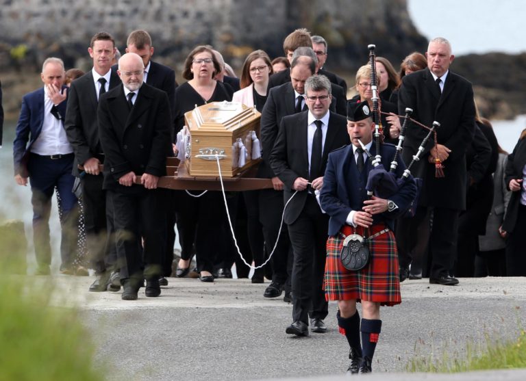 Scottish bagpiper leads funeral procession