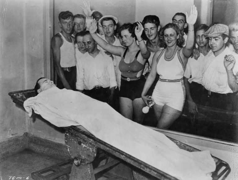 Dillinger body on table with crowd of specatators