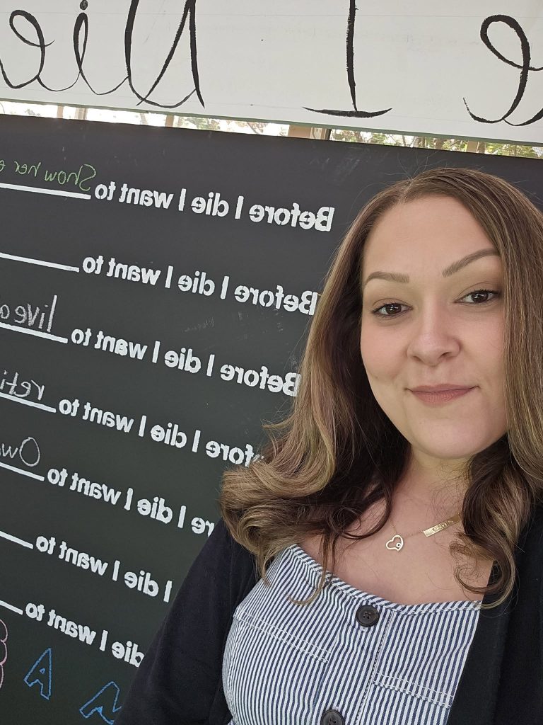 funeral director Erin Nagy in front of the “Before I Die” Wall